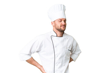 Young caucasian chef over isolated chroma key background suffering from backache for having made an...