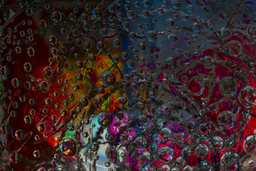 Space abstraction. Striped spheres are located against the red-yellow-blue background with spiral silhouette. 3D render. 