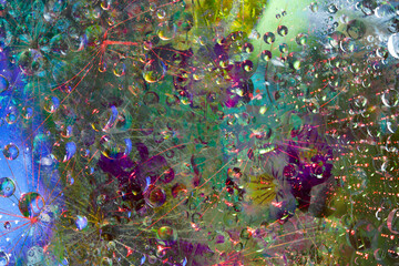 Translucent spheres are illuminated by rays of red light and are located against a green-blue-purple background.  Abstract fantasy. 3D render.