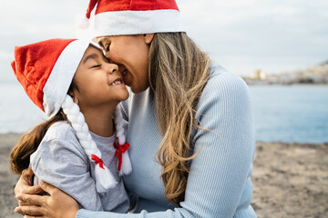 Happy Latin mother having a tender moment with her child during Christmas holidays - Family and holidays concept