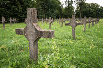 Polish garrison cemetery in the city of Brest. Rows of white crosses on green grass.