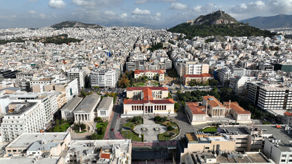 Fototapeta na wymiar Aerial photo of iconic landmark neoclassic buildings of Academy, University and public Library in the heart of Athens historic centre, Attica, Greece
