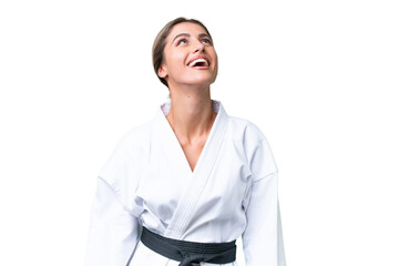 Young Uruguayan woman doing karate over isolated background laughing