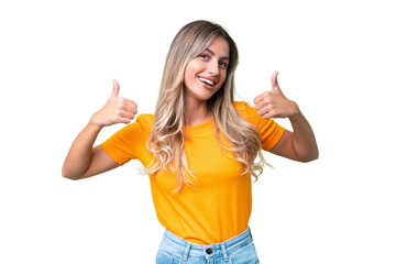 Young Uruguayan woman over isolated background giving a thumbs up gesture - obrazy, fototapety, plakaty