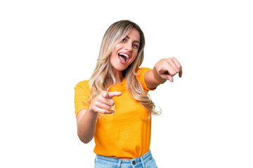 Young Uruguayan woman over isolated background pointing to the front and smiling