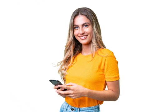 Young Uruguayan woman over isolated background sending a message with the mobile