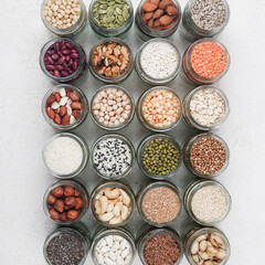 Vegan protein source. healthy vegetarian food. top view of seeds, nuts, peas, beans, rice, spelt, oatmeal on white background square