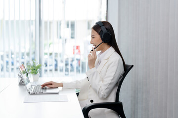 Smiling customer support service operator help desk. Young operator asian woman agent with headsets...
