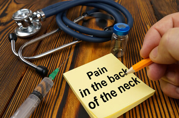 On the table is a stethoscope, a syringe and a sticker with the text - Pain in the back of the neck