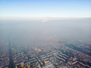 Aerial view of polluted city covered with smog