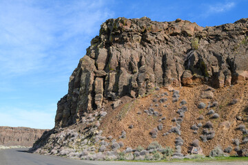 Fototapeta premium Basalt cliff at Frenchman Coulee rising above historic Highway 10 in Eastern Washington State