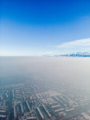 Aerial view of polluted city covered with smog