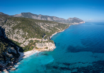 Fototapeta na wymiar the rugged mountainous coast near Cala Gonone with turqouise water and small white sand beaches