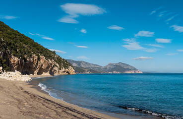 overhanging cliffs and sandy beach at Cala Luna on the east coast of Sardinia