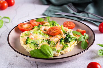 Omelet with broccoli and shrimp on a plate on the table. Homemade Protein Meal