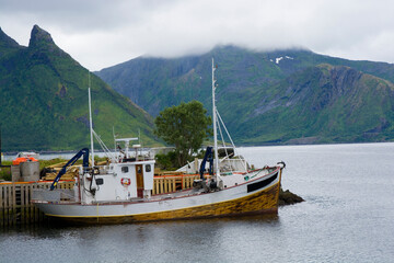 Fishing boat moored in a port in Oyfjorden, Husoy, Senja, Norway