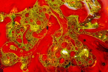 Fluid art colorful abstract background. Red-green stains of paint on liquid. reative pattern