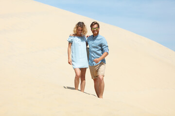 beautiful young couple relaxing walking on beach dunes