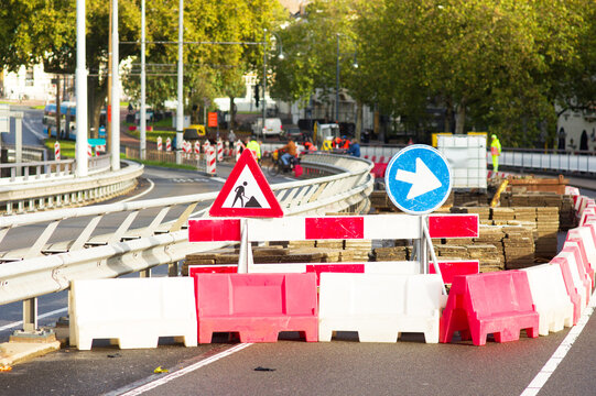 Work site closed with roadblocks for road works with people in the background  in the Netherlands