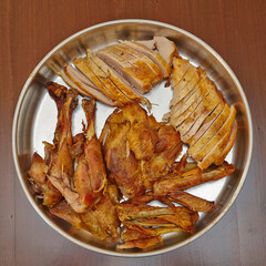 Tasty roasted turkey baked and cut, served in stainless steel pan. Top view closeup.