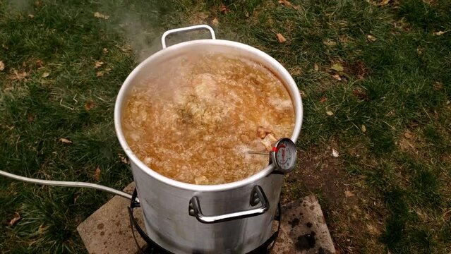 Boiling oil in large pot while Turkey being deep fried in it.