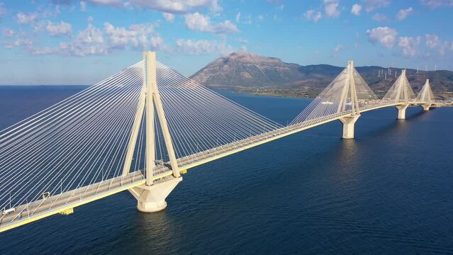 Aerial drone video of famous state of the art modern cable strait bridge of Rio Antirio crossing corinthian gulf from Peloponnese seaside city of Rio to Antirio - mainland Greece