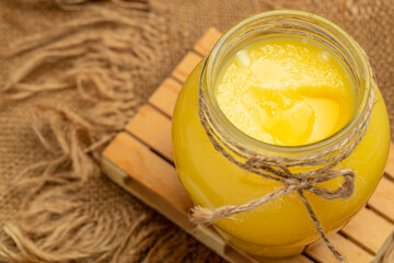 Homemade ghee Pure desi ghee in a bowl with wooden spoon, Healthy fats, clean eating for weight...