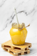 ghee oil. Ghee or clarified butter in jar on a light background. vertical image. top view. place for text