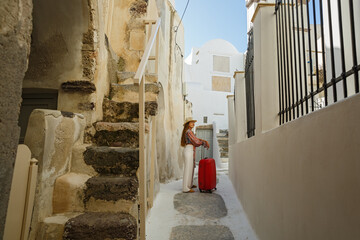 Young woman walks through the old streets in Greece