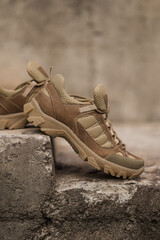Army sneakers on stones. Military footwear. Sneakers for mountain terrain