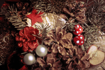 Weihnachtlicher Hintergrund Dekoration mit Zapfen und Kugeln Stern und Pilz Farben in rot und braun