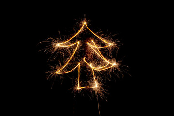 Christmas tree made by sparkler on a black background