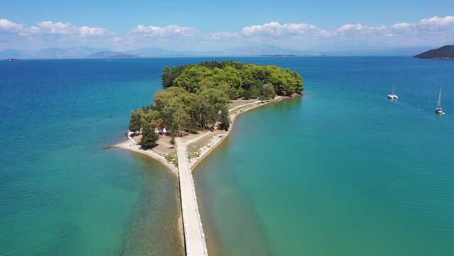 Aerial drone video of small islet of Koukoumitsa in picturesque seaside village of Vonitsa, Western Greece