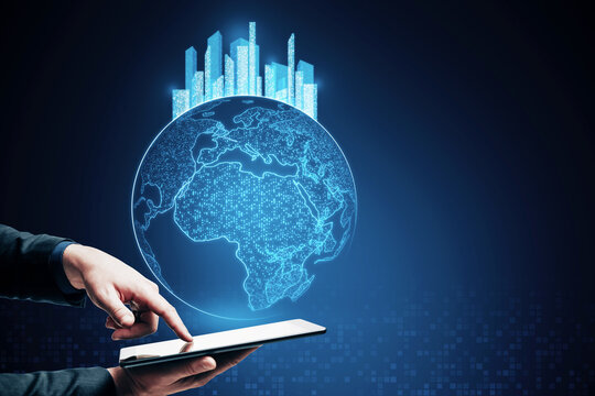 Close up of businessman hand pointing at tablet with glowing map with city hologram on blurry background with mock up place. Abstract metaverse virtual reality concept building and digital map.