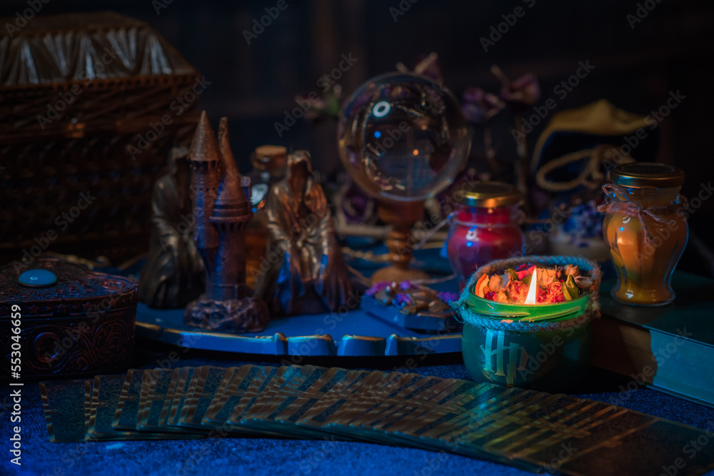 Wall mural Fortune-telling cards and burning candles on a table on mystic background 