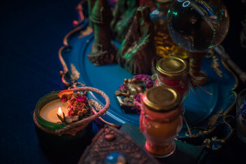 Fortune-telling cards and burning candles on a table on mystic background 