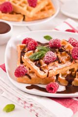 Waffles with raspberries and chocolate cream.