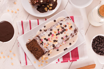 Sponge cake with white frosting and sugars.