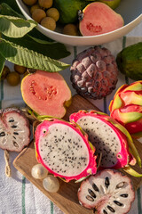 Variaty of tropical exotic fruits, ripe fresh lychee, dragon fruit, guava and cherimoya