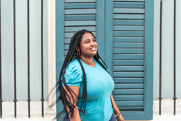 Portrait of black woman with braids on the street