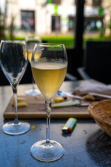 Tasting of white brut champagne wine outdoor in cafe in Reims, Champagne, France