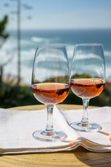 Tasting of sweet moscatel de setubal or porto portuguese wine and view on blue Atlantic ocean near Sintra in Lisbon area, Portugal