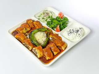 Traditional Turkish beyti Kebab with yoghurt, grilled tomatoes and fresh vegetables.