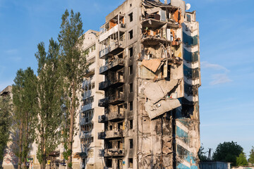 An exterior view of a high-rise residential building heavily damaged by a Russian artillery shells...