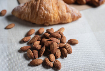 Topview shot of almonds with big slices of bread on dark wooden background concept of health care

