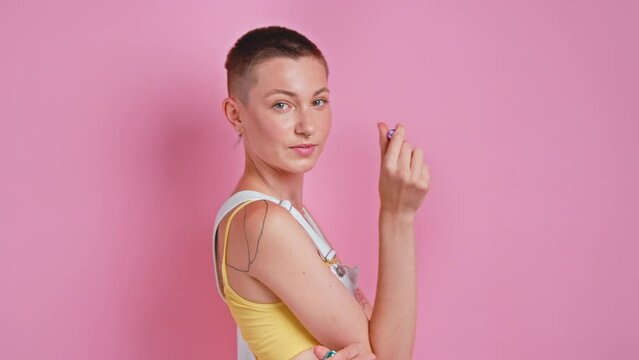Short haired woman feeling passionated while looking at the vacuum stimulators