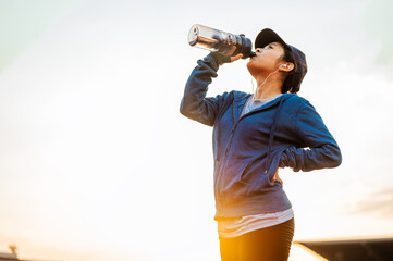 Stop resting and Drink whey protein rest after running jogging on the running track around in the...