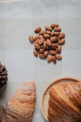 Topview shot of almonds with big slices of bread on dark wooden background concept of health care
