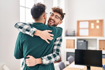 Young couple business workers hugging each other at office