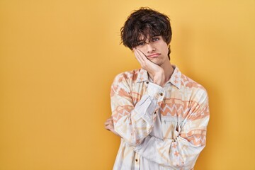 Fototapeta premium Young man wearing casual summer shirt thinking looking tired and bored with depression problems with crossed arms.